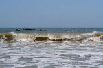 Fishermen awaiting for the right surf to return to shore after spending the night at sea fishing - Morondava, Madagascar.